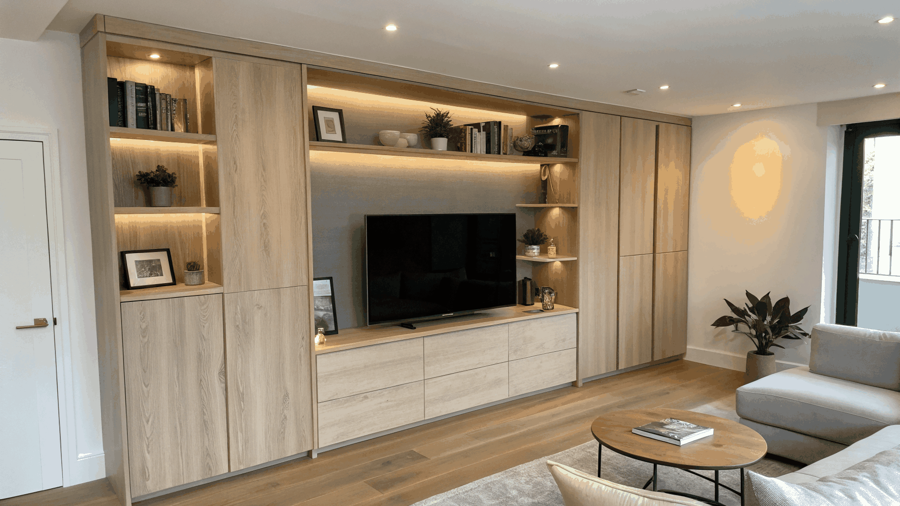 Built-in living room cabinetry and library wall with integrated lighting